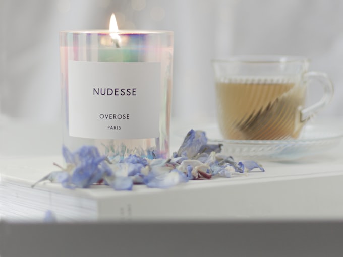 A warm cup of tea beside a lit candle